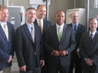 James Worden, CEO of SE, and Deval Patrick at ribbon cutting of a solar array